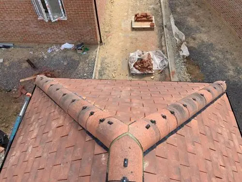 Residential building site new roof with dry ridge system